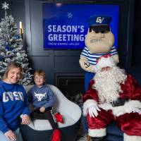 Mother and son smile with Santa and Louie